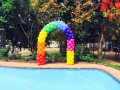 Rainbow balloon arch for pool party